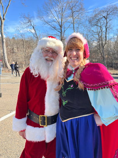 Santa and Princess Anna smile for a photo