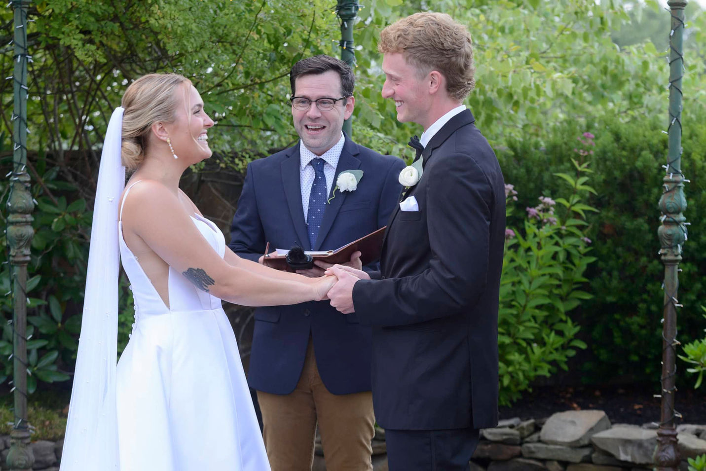 Bride and groom smiling during wedding ceremony.
