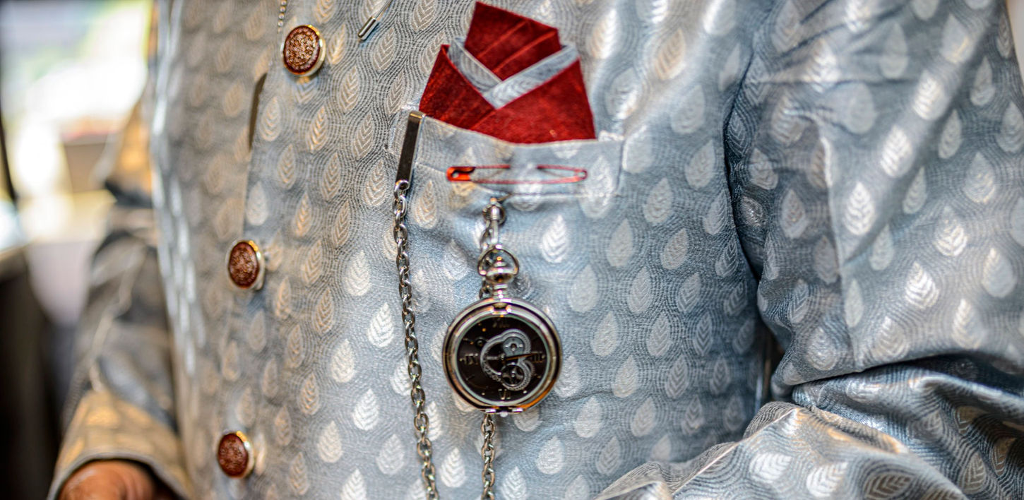 Close-up of fathers pocket watch as a statement hanging from his embroidered Sherwani, captured by Boston wedding photographer Ron Richman in Boston, Massachusetts.