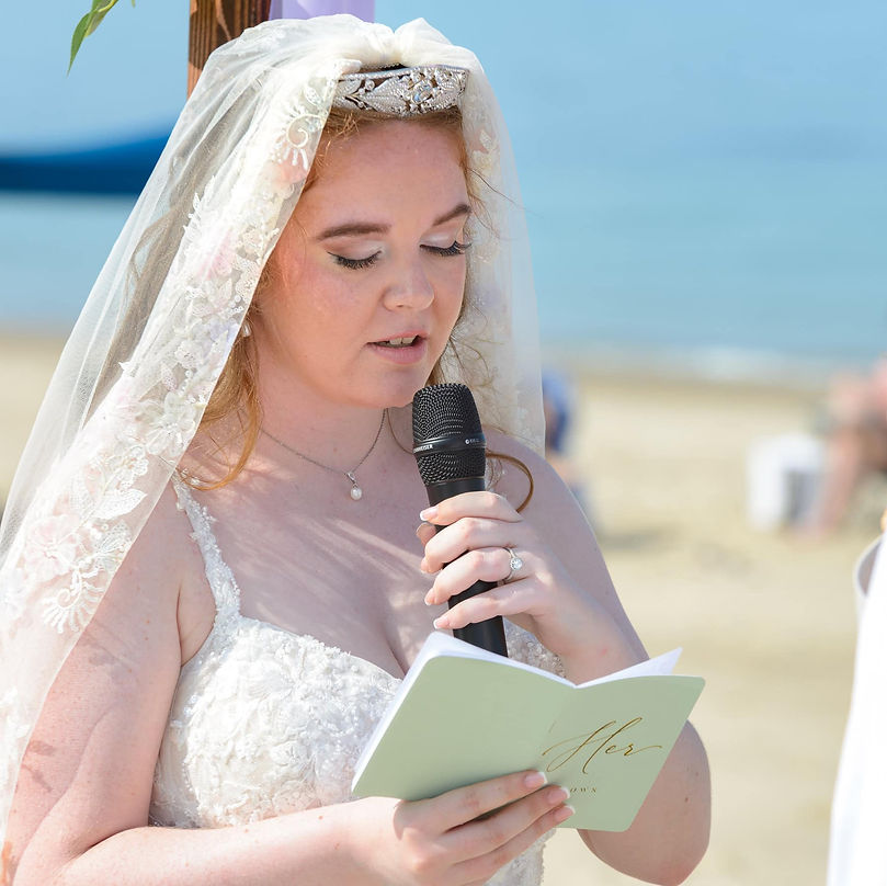 bride-reading-her-vows-on-the-beach.jpg