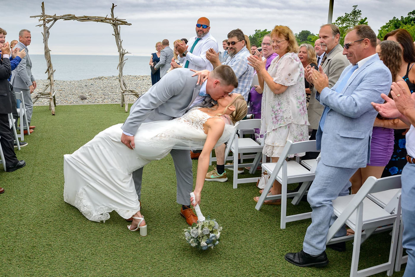 ocean-beach-wedding-newlyweds-dip-kiss.jpg