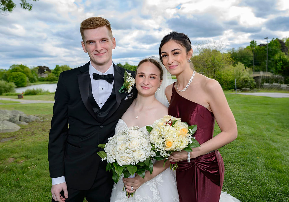 newlyweds-and-sister-posing-with-bouquets.jpg