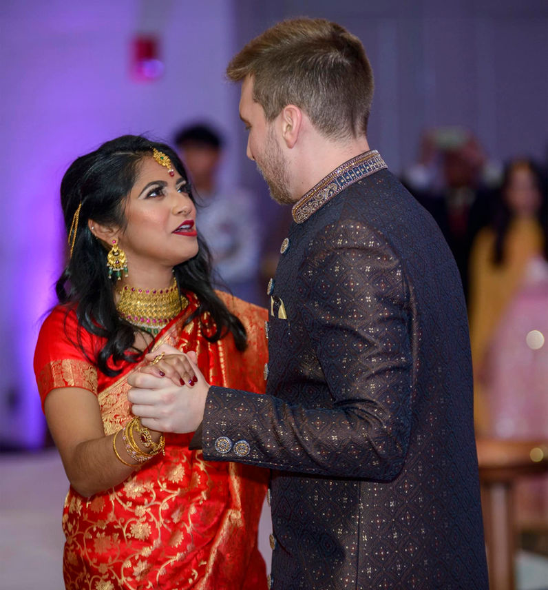 Bride looking up lovingly at her groom while dancing.