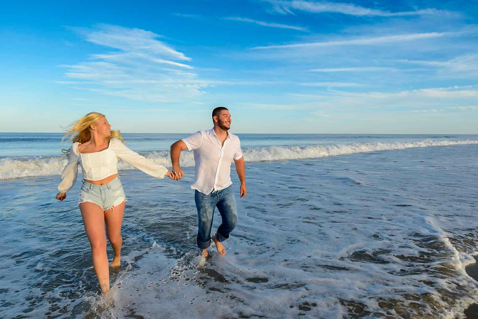 couple-running-through-the-water-holding-hands.jpg