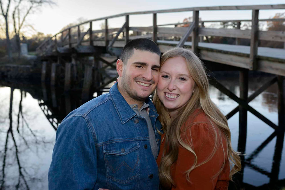 engaged-couple-standing-in-front-of-the-old-north-bridge.jpg