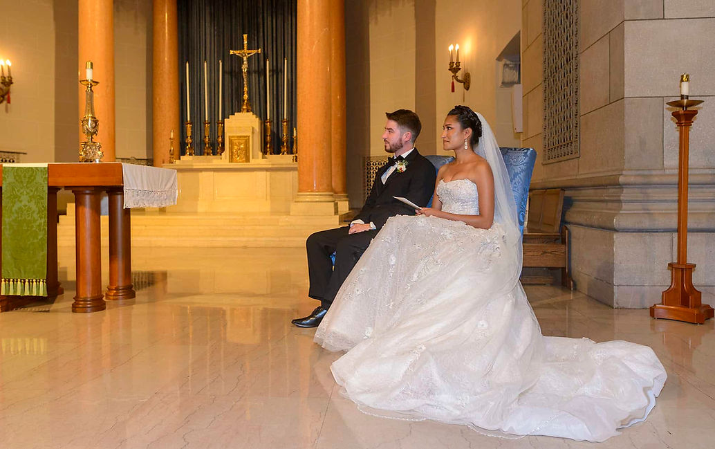 Bride and groom seated together during a chapel wedding ceremony.