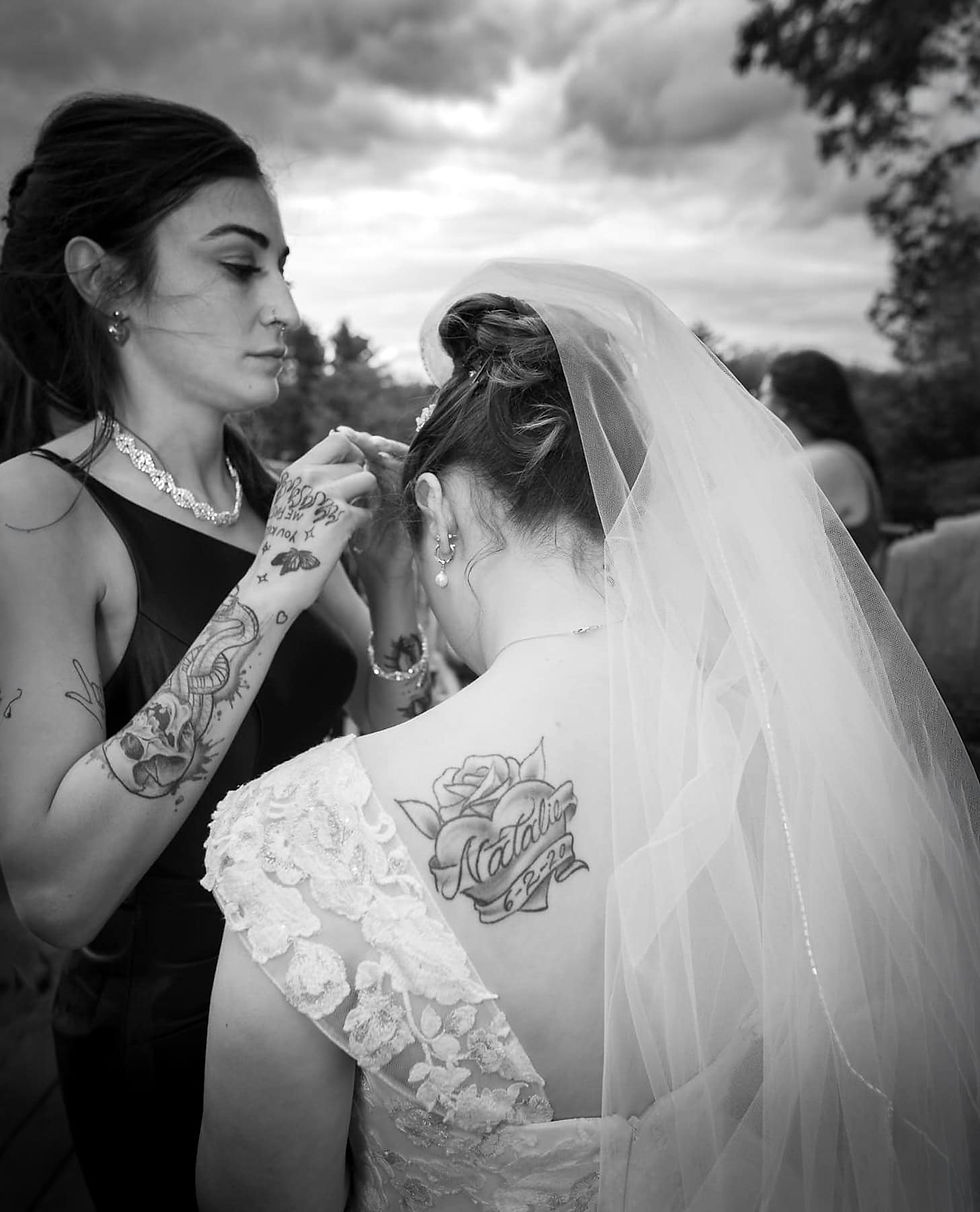candid-sisyter-fixing-brides-hair-veil-tattoo.jpg