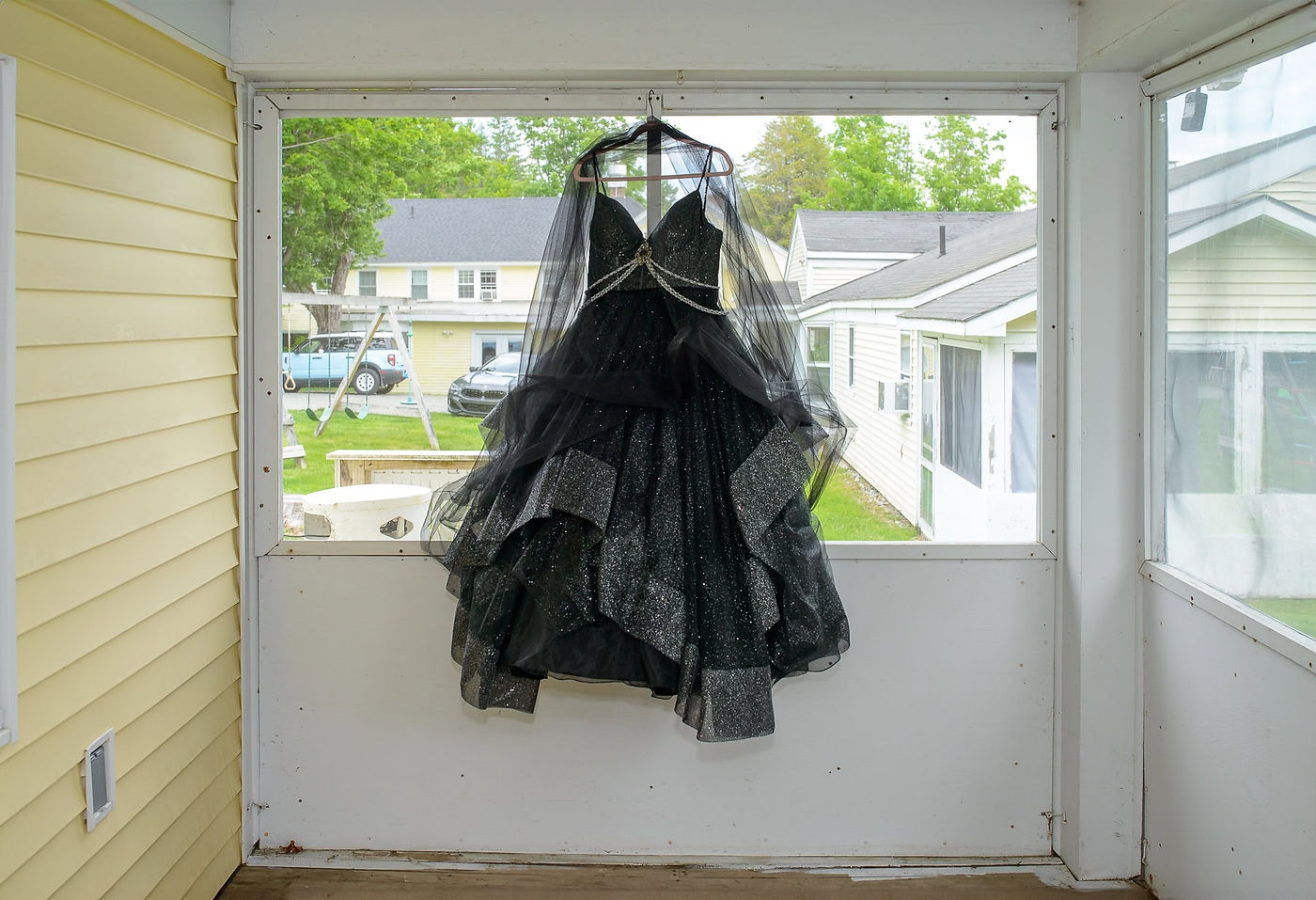 black-wedding-dress-hanging-in-the-porch-window.jpg