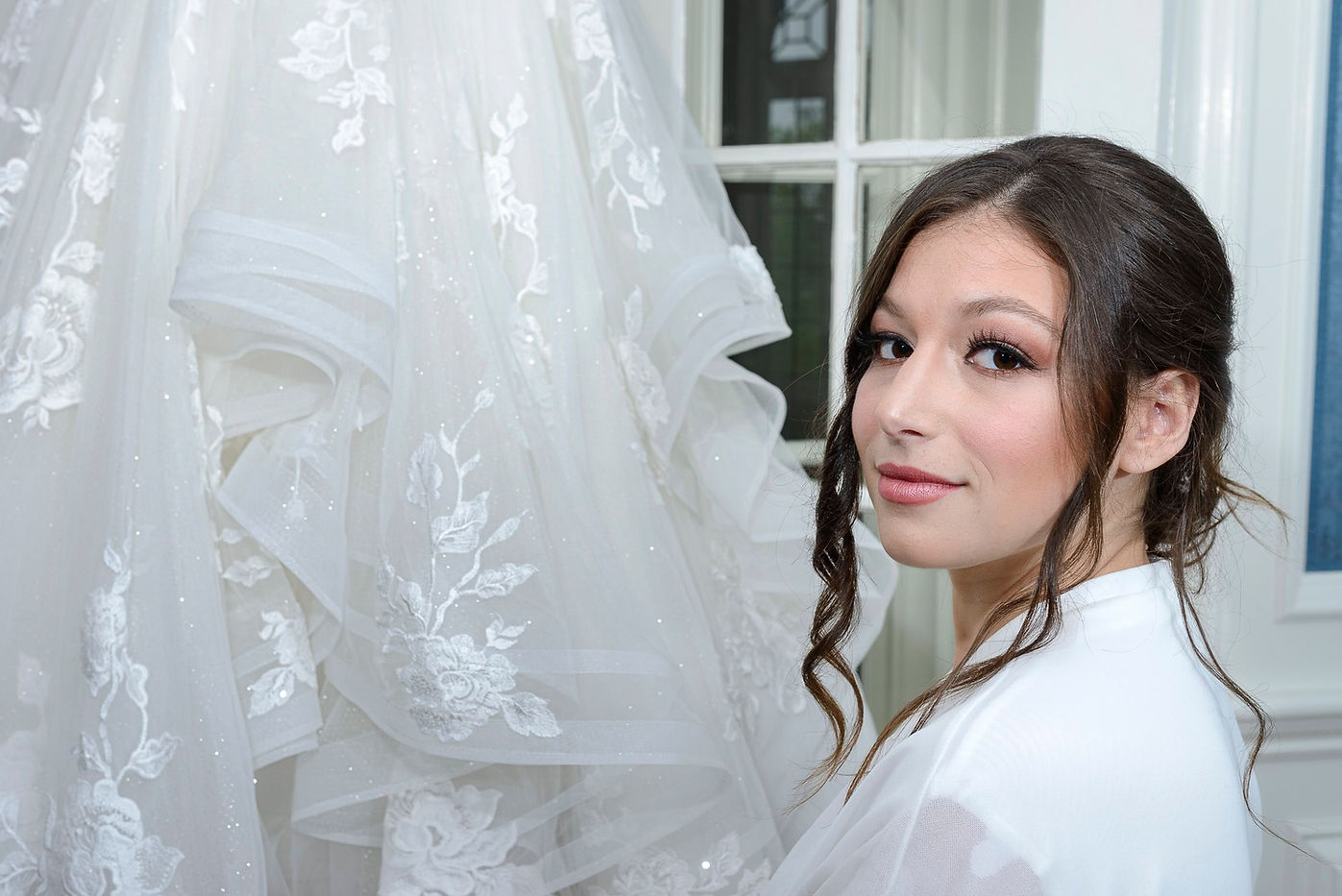 close-up-bride-standing-next-to-wedding-dress.jpg