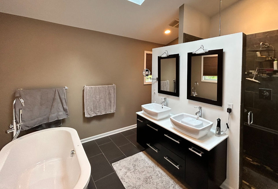 Freashly painted bathroom with a neutral color white accent wall and a large soaking tub.