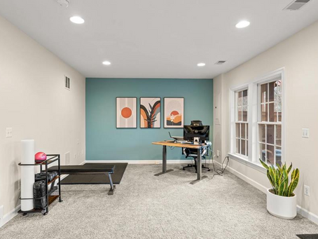 Newly painted office with neutral colored off-white walls featuring a blue accent wall.