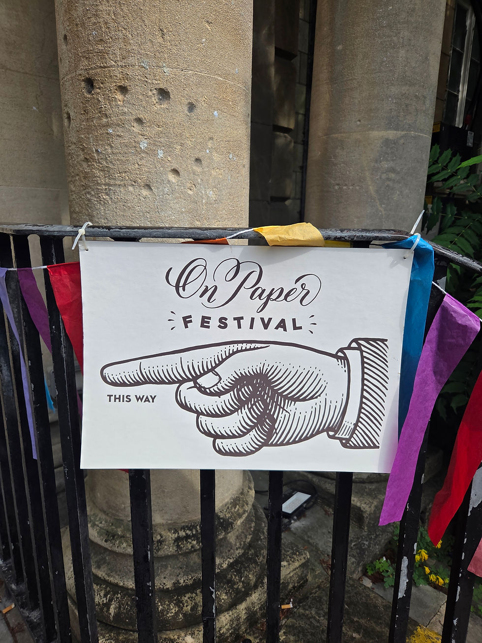 An image of a hand pointing towards a festival door