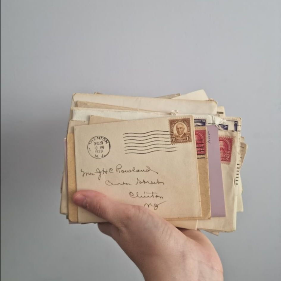 A hand holding envelopes