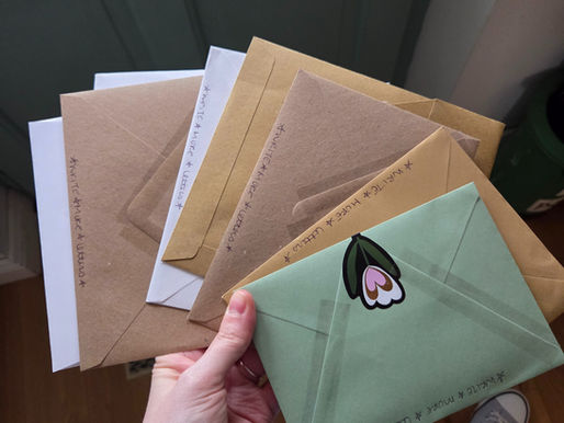 a hand holding a bundle of letters