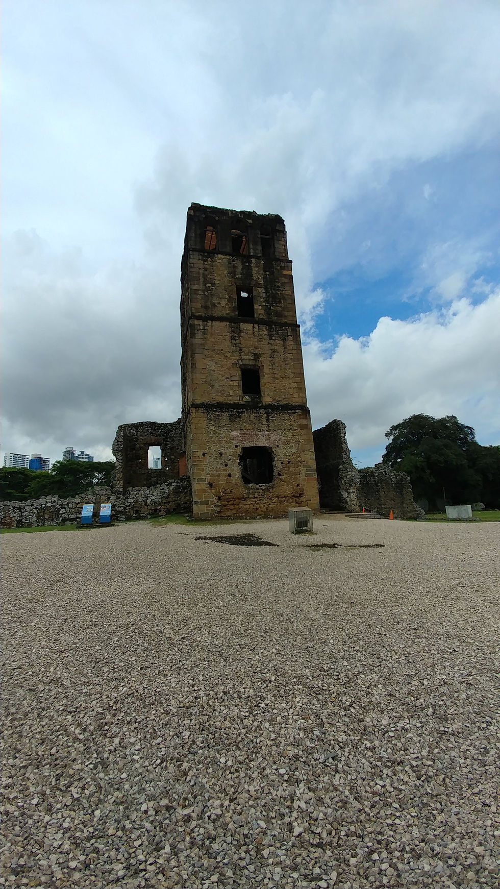 Historic stone bell tower and ruins of Panamá Viejo in Panama City, Panama, beneath a partly cloudy sky.