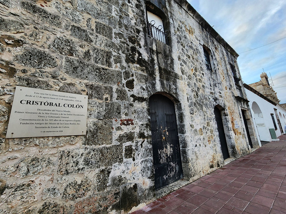 Historic stone building in Zona Colonial, Santo Domingo, with a plaque identifying it as the last residence of Christopher Columbus in the Americas.