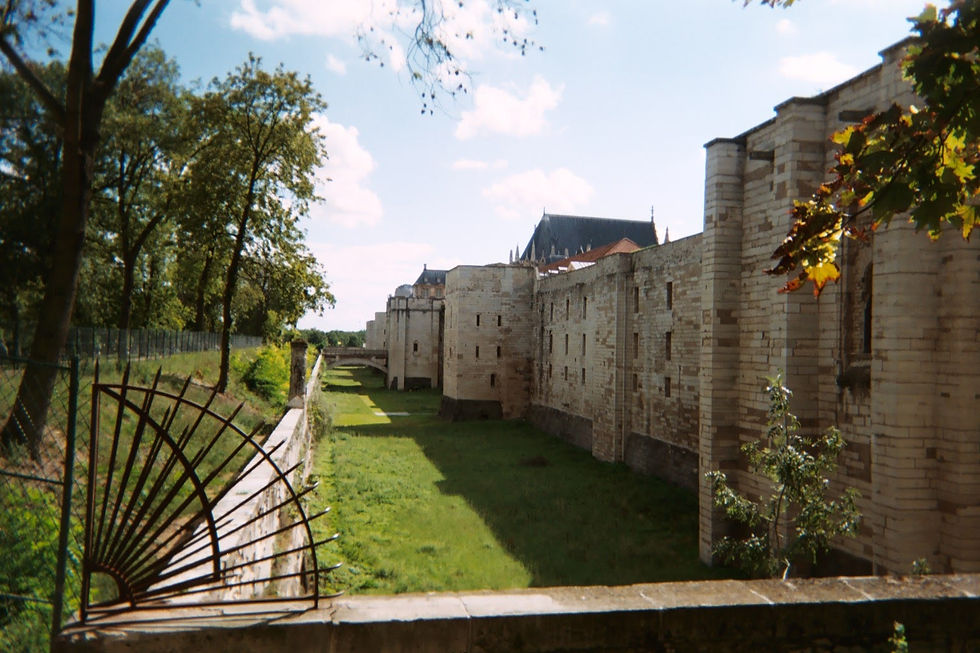 Outer defensive wall and moat of the Château de Vincennes, surrounded by trees in Vincennes, France.