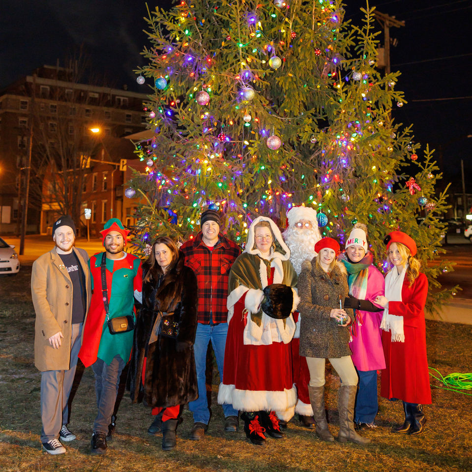 Group photo with Santa by large Christmas tree