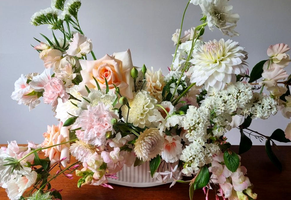 Summer signing table flower arrangement sitting on side table