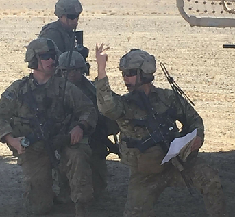 Red Patch Roofing team member in uniform reviewing roofing plans on site