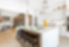 Open concept white modern kitchen and large dining room.