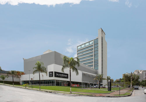 Fachada moderna do edifício onde está localizado o consultório da Janaina, com áreas verdes ao redor e design contemporâneo.