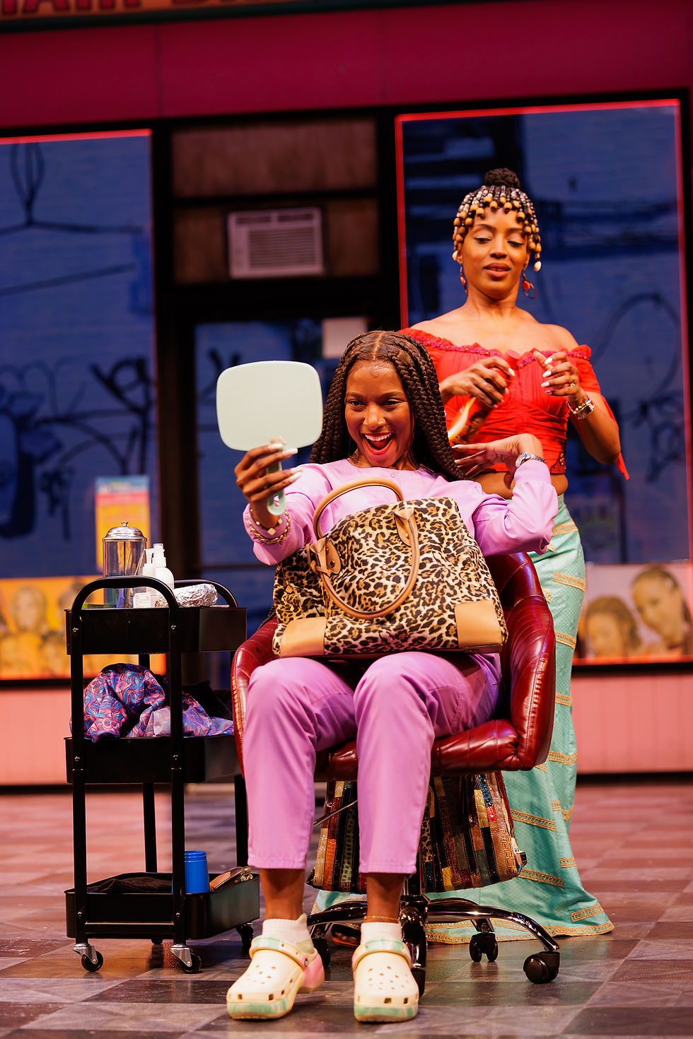 Leovina Charles and Tiffany Renee Johnson in La Jolla Playhouse's production of jAJA'S AFRICAN HAIR BRAIDING, by Jocelyn Bioh, Directed by Whitney White, Now Playing from May 17 - June 15.