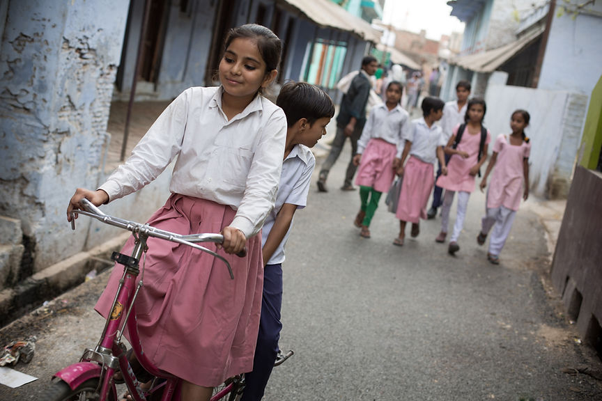 090. Mahi Soni (12) gives a classmate a ride after school in Hardoi.jpg
