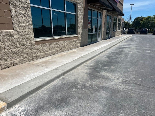 Concrete sidewalk and curb repair work completed for a local retail store