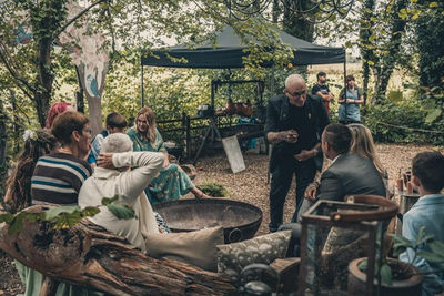 Wedding guests laughing as Adam Smith performs
close up magic at Wilderness Weddings for Nicola and James wedding