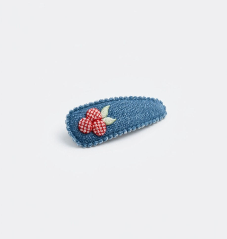 Sweet Blossom snap hair clip featuring embroidered cherry blossom detail on a blue fabric-covered snap clip