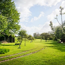 Bredy Farm is a vibrant, family-run working farm nestled in the picturesque Bride Valley along Dorset’s scenic Jurassic Coast, just on the outskirts of Burton Bradstock. Operating as an adults-only rustic campsite from Easter through September, the farm has earned a reputation for combining a laid-back rural escape with an energetic, party-friendly atmosphere. It is widely celebrated for its on-site Italian restaurant, home-produced craft ciders, microbrewery, and lively weekend live music events.