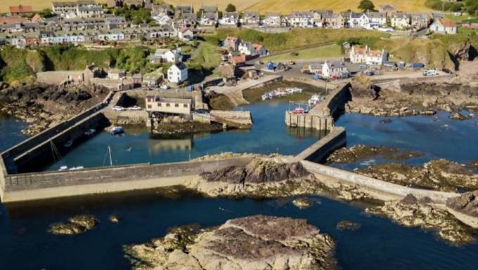 St Abbs Harbour is a spectacularly picturesque, traditional working fishing harbour nestled at the foot of dramatic cliffs on the Berwickshire coast of southeastern Scotland. Known for its crystal-clear waters and striking coastal scenery, this compact haven serves as a vibrant hub for the local community, scuba divers, and tourists seeking a peaceful retreat.