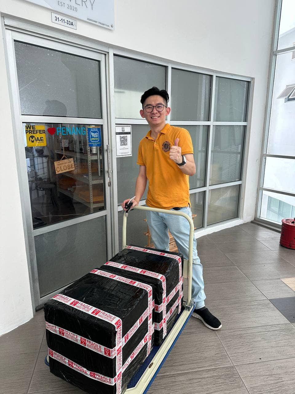 Edwin at post office to deliver kombucha to kl