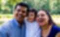 Latino parents with their son, smiling and laughing.jpg