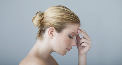 Woman Touching Forehead with headache pain