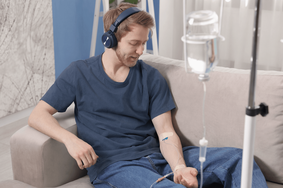 person-receiving-iv-infusion-sitting-on-couch.png
