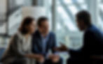 professional portrait of couple talking to lawyer.jpeg