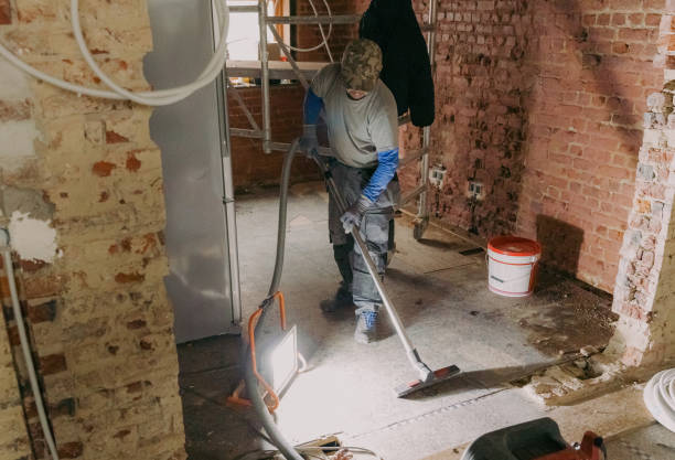 man cleaning a room after construction