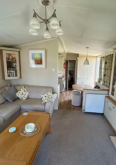 Open plan living and kitchen area decorated in neutral beige colours