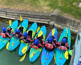 Six participants in kayaks on the lake