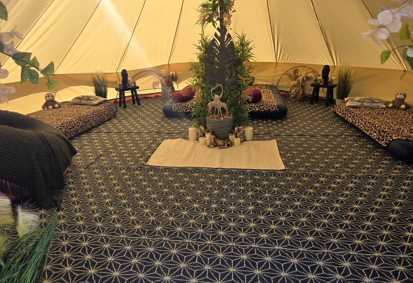 Inside bell tent decorated in safari style with four air mattresses