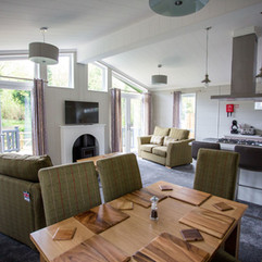 Open plan lounge, dining room and kitchen area of the Country luxury holiday lodge at Lee Valley Caravan Park, Dobbs Weir
