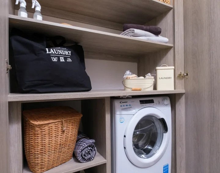 Utility room with ample storage and tucked away washing machine