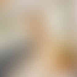 Inside a glamping pod with bed, settee and fold down table