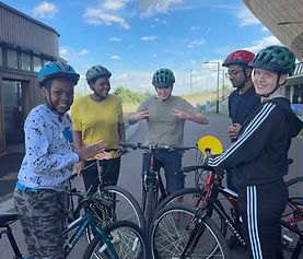 Five young adults with bikes on the road circuit at Lee Valley VeloPark