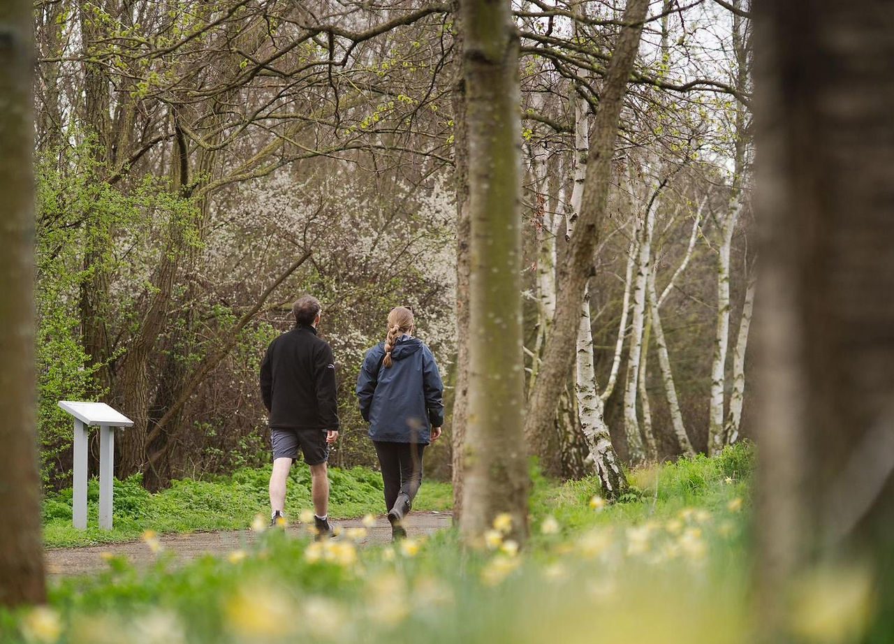 Two people walking along a pathways in Bow Creek Ecology Park