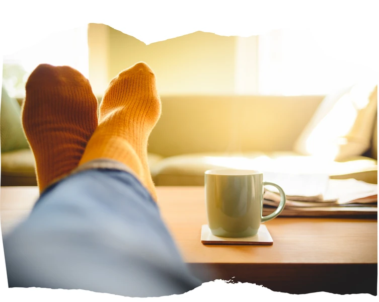 calmly enjoying a cup of coffee with feet up, relaxing