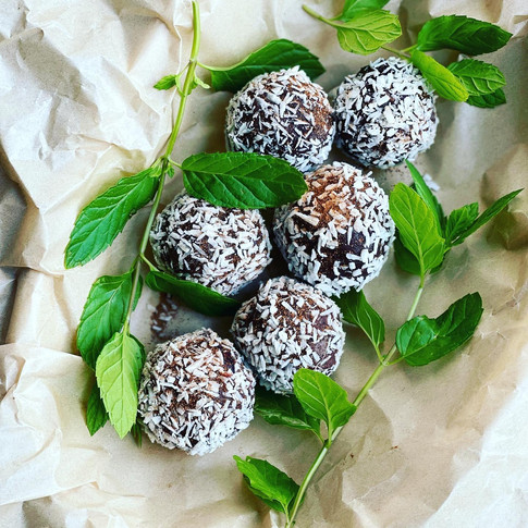 Raw vegan cacao ball coded with coconut flake