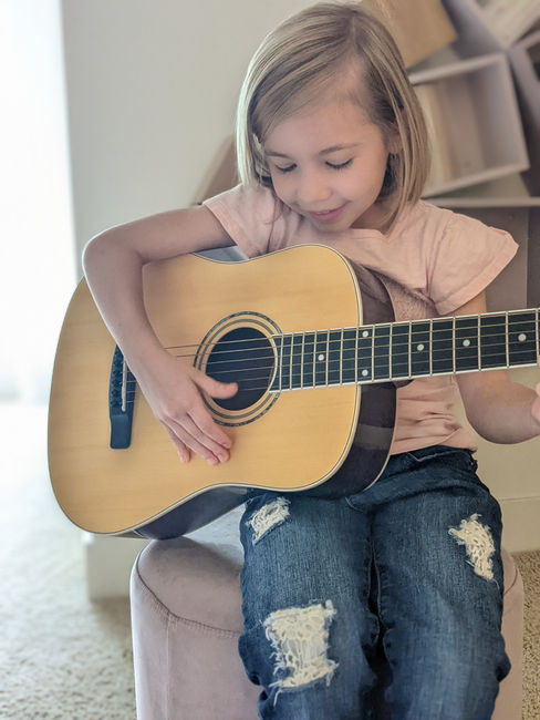 Girl playing acoustic guitar